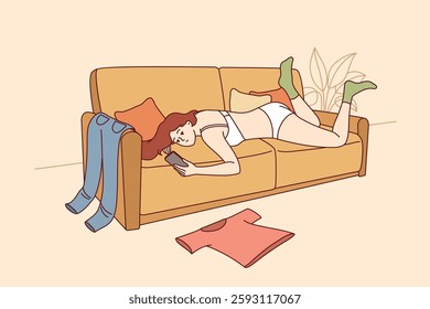 Lazy woman in underwear lies on sofa and uses phone, not paying attention to chaos in apartment. Scattered things around lazy girl who suffers from procrastination and does not want to clean room.