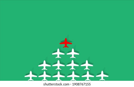  leadership concept with red paper plane leading among white on green background.