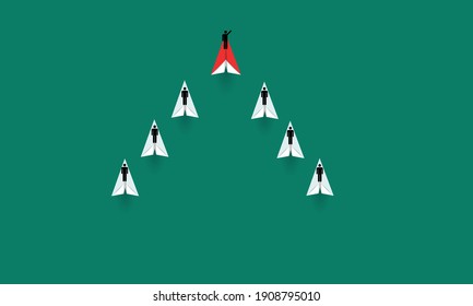 Leadership concept with red paper plane leading among white on green background