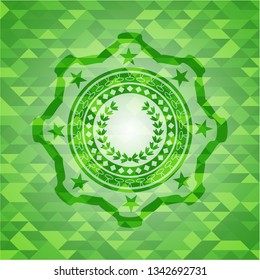 leaf crown icon inside green mosaic emblem