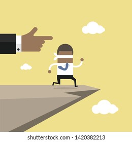 Leap of faith concept. Blindfolded African businessman walks off a cliff.
