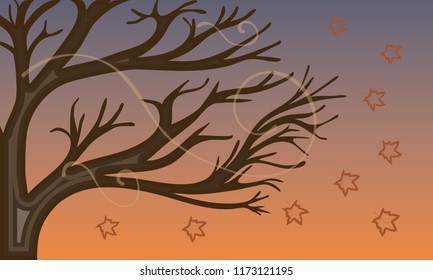 Leaves falling from a tree moved by the wind in autumn.
