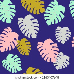 Leaves monstera on a dark background. Bright colored leaves on blue background. Seamless pattern.