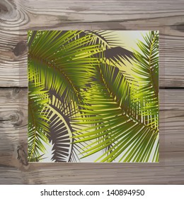 Leaves of palm trees on the background of wooden boards