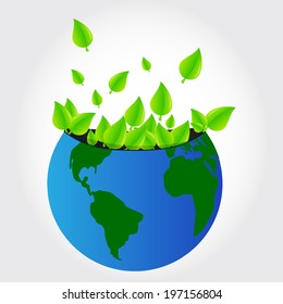 Leaves of trees coming out of the planet earth. Green leaves planet