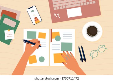 Left hand author writing planning on notebook. Workplace with mobile phone, cup of coffee, laptop. Vector illustration.