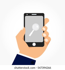 left hand holding a black smart phone with a magnifier symbol on its grey screen
