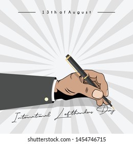 left hand writing "international lefthanders day" with a ballpoint, which is celebrated on August 13