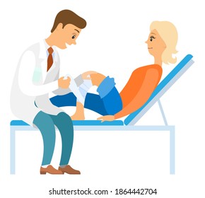 Leg injured patient doing consultation to a doctor. The girl lies on the bed and looks at the man. Patient and doctor isolated on white background. Orthopedist puts a bandage on the knee of a woman