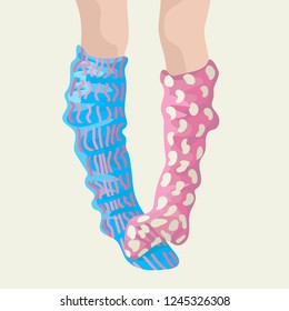 Legs in different socks, one person two golfs. Different patterns.