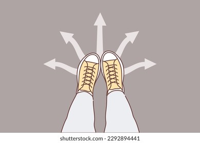 Legs man at crossroads near arrows pointing in different directions, symbolizing way to solve problems. Boots at crossroads requiring decision in face of uncertainty and existence of alternative plans