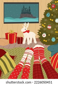 Leisure during the Christmas holidays. Couple in christmas socks watching a movie. Cozy interior.