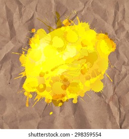 Lemon made of colorful splashes on a crumpled paper background
