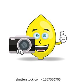 Lemon mascot character holding camera. vector illustration