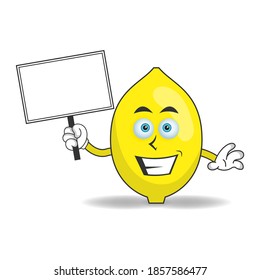 Lemon mascot character holding a white blackboard. vector illustration