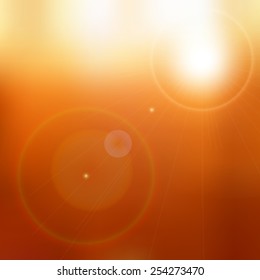 Lens flare on blurred orange and brown background