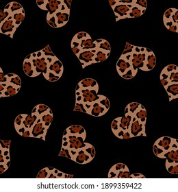 Leopard hearts on a black background. The pattern is suitable for textiles, clothes. Bright animal print. Contrast ornament for packaging and wallpaper