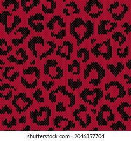 Leopard jacquard knitted seamless pattern with heart shape spots. Red and black background for knitwear design or print. Vector illustration.