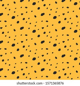 Leopard print. Vector ornament with black dots on a yellow background. Wild pattern. Cheetah pattern