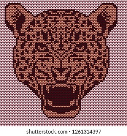 Leopard's head in the open mouth. Knitted pattern.