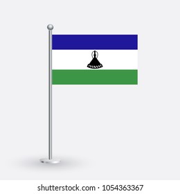 Lesotho flag. The national flag of Lesotho on a pole. The waving flag. The sign and symbol of the country. Realistic vector on white.