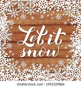 Let is snow calligraphy hand lettering on wood background with snowflakes. Christmas, New Year and winter holidays typography poster. Vector template for greeting card, banner, flyer, postcard.