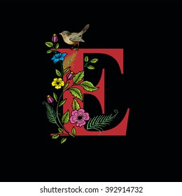 Letter E with flowers and bird on black background, vector