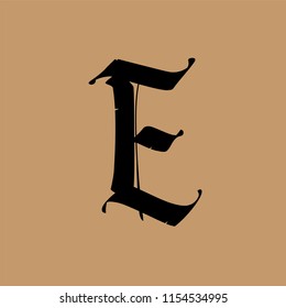 Letter E, in the Gothic style. Vector. Alphabet. The symbol is isolated on a golden background. Calligraphy and lettering. Medieval Latin letter. Logo for the company.   Elegant font for tattoo.