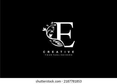 letter E logo design with flowers, leaves and feathers in a beautiful and elegant style. monogram E. typography E. initial E logo. suitable for, business, wedding, boutique, company, hotel, etc