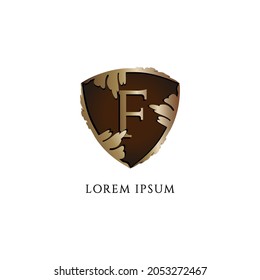 Letter F alphabet logo design isolated on white background. Luxury Decorative metallic gold shield sign illustration. Protection, Guard, Security. Initial abjad logo concept. Insurance Company Logo