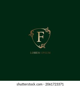 Letter F Alphabetic logo design template. Luxury gold decorative floral shield sign illustration isolated on dark green background. Insurance logo concept