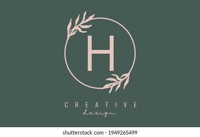 Letter H Logo with circle frame and pastel leaves design. Rounded vector illustration with letter H and pastel leaf for beauty, fashion, jewelry, luxury, natural products or eco services.