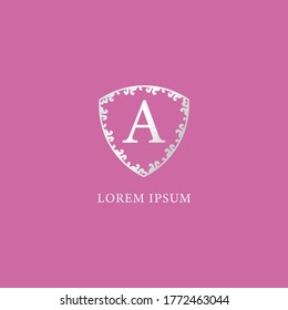A Letter Intial logo design template. Luxury silver decorative floral shield illustration isolated pink color background. Suitable for Insurance, fashion and beauty product