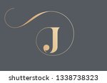 Letter J logo.Typographic icon in golden color isolated on dark background.Serif uppercase lettering.Initial character with round frame and swirl.Luxury style sign.