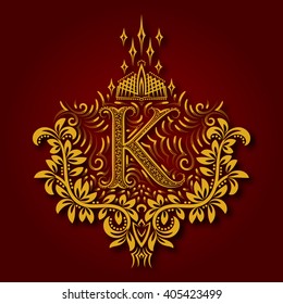 Letter K heraldic monogram in coats of arms form. Vintage golden logo with shadow on maroon background. Letter K is surrounded by floral elements of design.