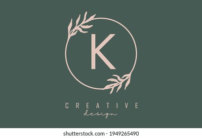 Letter K Logo with circle frame and pastel leaves design. Rounded vector illustration with letter K and pastel leaf for beauty, fashion, jewelry, luxury, natural products or eco services.