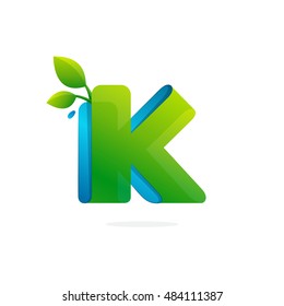 Letter K logo formed by ribbon with leaves and drops. Font style, vector elements for posters, t-shirts and cards.