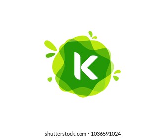 Letter K logo at green watercolor splash background. green nature logo vector
