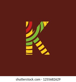Letter K logo on dark background with bright colors, African culture, safari decoration
