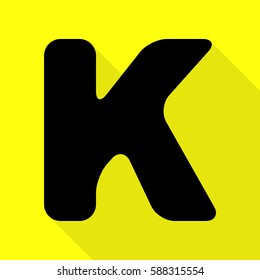 Letter K sign design template element. Black icon with flat style shadow path on yellow background.