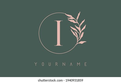 I Letter logo design with with dust pink circle and leaves on a green background. Initial Letter I Vector Illustration with Botanical elements. Nature vector template design concept with i letter.