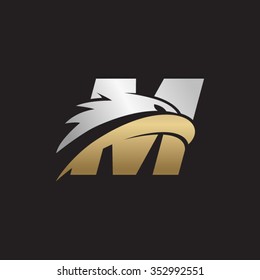 letter M eagle head silver gold logo black background