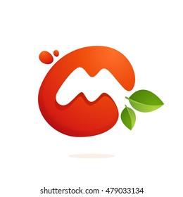 Letter M logo in fresh juice splash with green leaves. Vector elements for natural application, ecology presentation, business card or cafe posters.