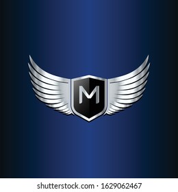 letter M shield with wings gold color logo design concept template vector 3d heraldic shield and wings logo gold / silver emblem