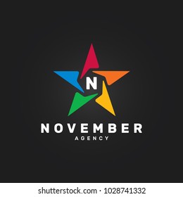 Letter N Abstract rainbow star vector design element on black background. Corporate logotype template.