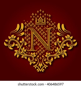 Letter N heraldic monogram in coats of arms form. Vintage golden logo with shadow on maroon background. Letter N is surrounded by floral elements of design.