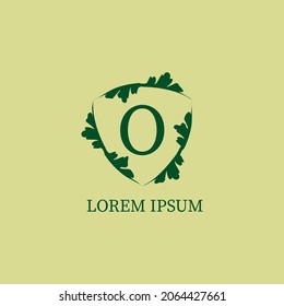 Letter O alphabetic logo design template. Decorative floral shield sign illustration. Nature Guard, Security logo concept isolated on green beige color.