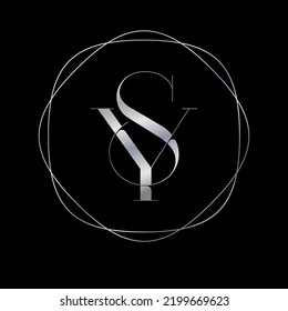 The Letter S And The Letter Y. The SY Monogram Consists Of Silver Letters Intertwined In A Thin Frame.