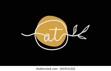 Letter AT or TA boho style botanical logo in flat minimal design symbol