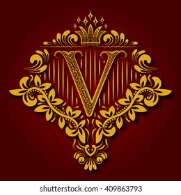 Letra V monograma heráldico en escudos de armas. Logo dorado vintage con sombra sobre fondo marrón. La carta V está rodeada de elementos florales de diseño.